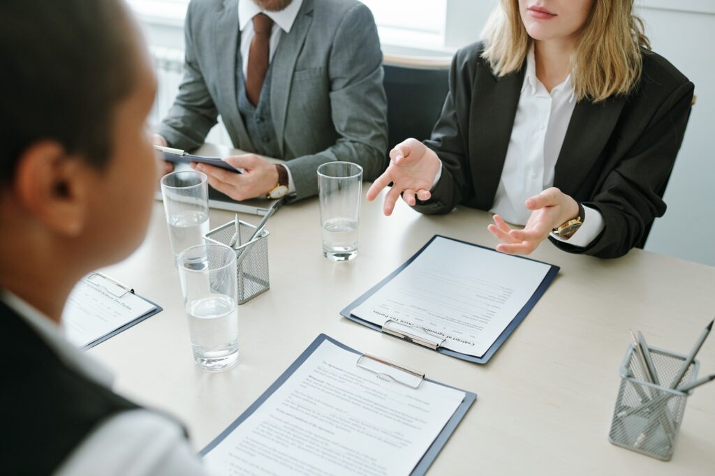 hands of young businesswoman in formalwear over contract or financial documents.jpg