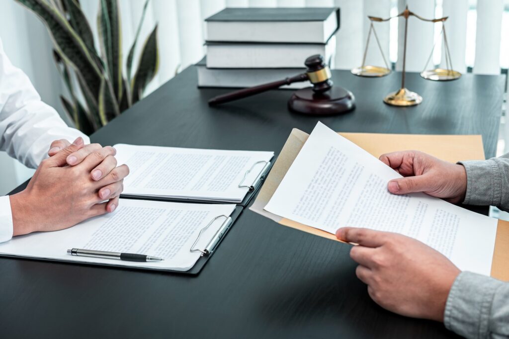 male lawyer discussing negotiation legal case with client meeting with document contract in office 1.jpg