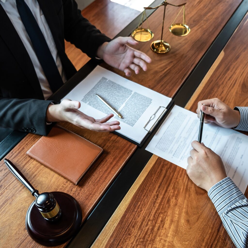 male lawyer discussing negotiation legal case with client meeting with document contract in office.jpg