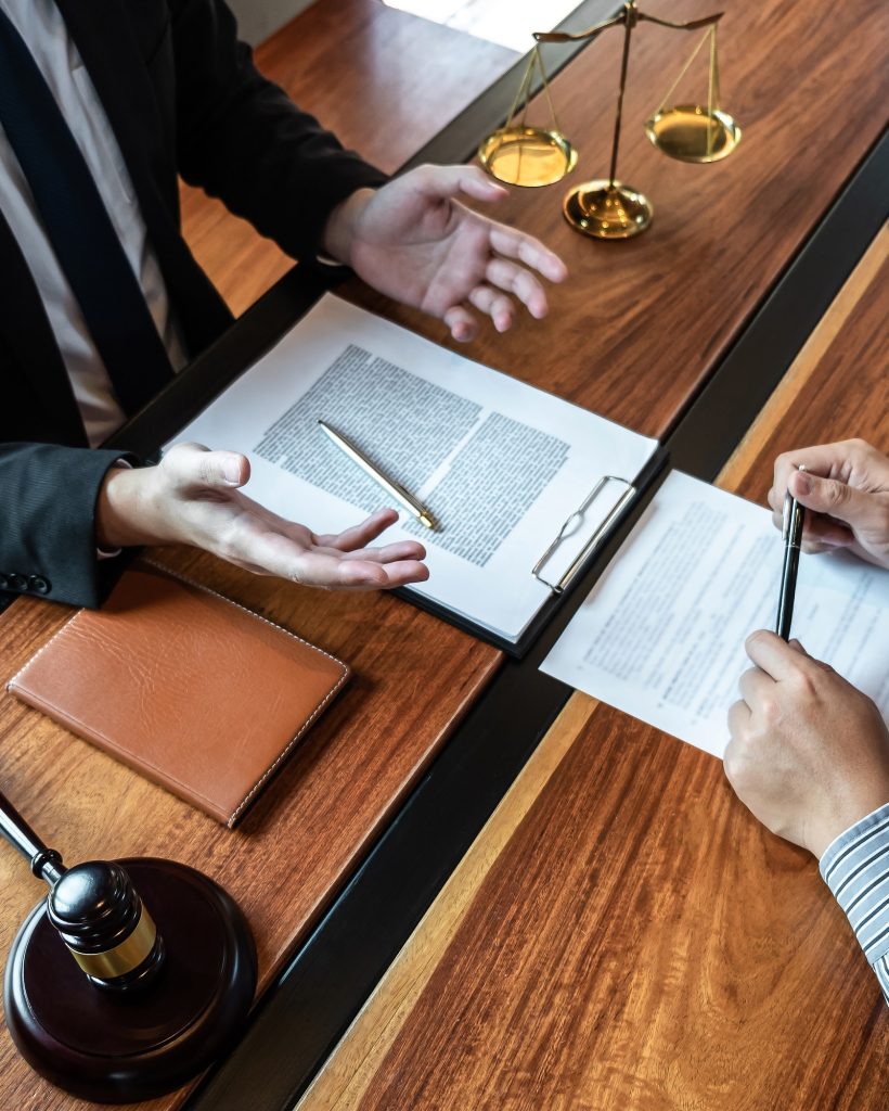 male lawyer discussing negotiation legal case with client meeting with document contract in office.jpg