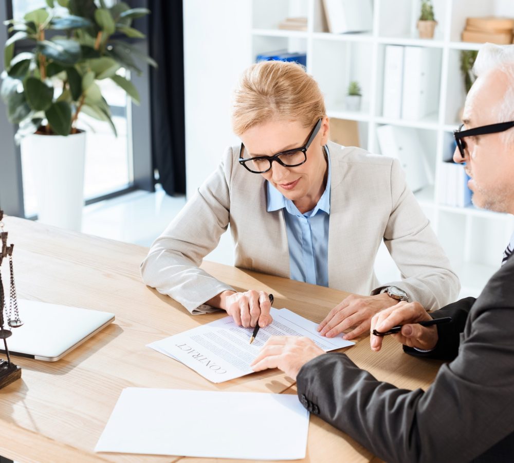 mature lawyers looking at contract in modern workplace 1.jpg