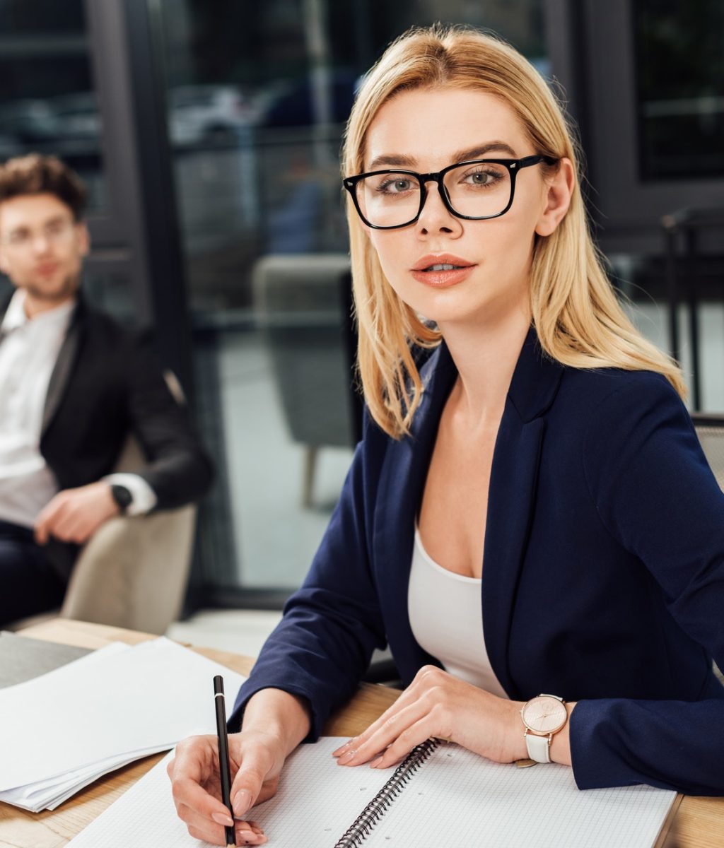 selective focus of businessman looking at businesswoman in eyeglasses that looking at camera at.jpg