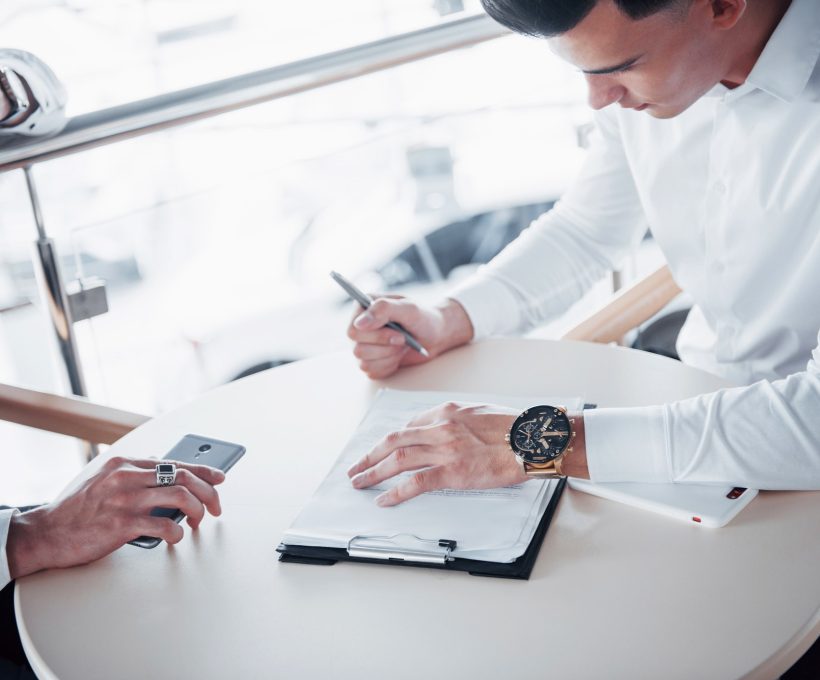 young man signs documents in the office successful sales.jpg